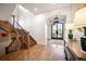Grand foyer with hardwood floors, staircase, and view of the entry at 455 Forest St, Denver, CO 80220
