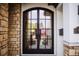 Elegant home featuring a double-door front entry with stone arch and trim at 455 Forest St, Denver, CO 80220
