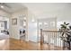 Bright hallway with hardwood floors, leading to bedrooms, stairs and laundry room at 455 Forest St, Denver, CO 80220