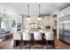Spacious kitchen with white cabinets, stainless steel appliances, and a large island at 455 Forest St, Denver, CO 80220