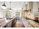 Modern kitchen features marble countertops, stainless steel appliances, and hardwood floors at 455 Forest St, Denver, CO 80220