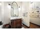 Stylish powder room with a vessel sink, decorative mirror, and elegant lighting fixtures at 455 Forest St, Denver, CO 80220