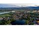 Panoramic aerial shot of community near a serene lake and mountains in the distance at 6266 Holman St, Arvada, CO 80004