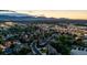 Scenic aerial view of a neighborhood with mountain views, mature trees, and convenient access to amenities at 6266 Holman St, Arvada, CO 80004