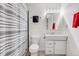 Bathroom featuring a toilet and sink, cabinet, mirror, and shower with a striped curtain at 6266 Holman St, Arvada, CO 80004