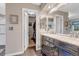 Bright bathroom featuring a marble countertop vanity and open doorway to the spacious walk-in closet at 6266 Holman St, Arvada, CO 80004