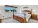 Bedroom features a large bed, window view, and hardwood nightstands with vintage lamps at 6266 Holman St, Arvada, CO 80004