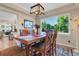 Elegant dining room with wood table, chairs, area rug, and large window with outdoor views at 6266 Holman St, Arvada, CO 80004