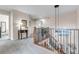 Hallway with wood railing and views into other rooms at 6266 Holman St, Arvada, CO 80004