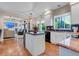 Bright kitchen with white cabinets, granite countertops, and a seamless flow into the living spaces at 6266 Holman St, Arvada, CO 80004