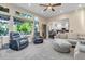 Bright living room with fireplace and outside views from large windows at 6266 Holman St, Arvada, CO 80004