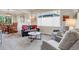 Cozy living room with plush seating, neutral carpet, and a view into the dining area at 6266 Holman St, Arvada, CO 80004