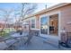 Back patio area with table, chairs, and sliding glass door at 8403 S Miller Ct, Littleton, CO 80127