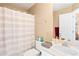 Bathroom with tub and shower with curtain, toilet, vanity with sink, and lighting at 8403 S Miller Ct, Littleton, CO 80127
