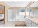 Well-lit bathroom with a soaking tub, shower, and white vanity with sink at 8403 S Miller Ct, Littleton, CO 80127