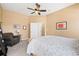 Comfortable bedroom with ceiling fan, seating area, and access to ensuite bathroom at 8403 S Miller Ct, Littleton, CO 80127