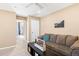 Inviting bonus room with comfortable seating, and a view to the main door at 8403 S Miller Ct, Littleton, CO 80127