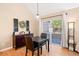 Dining room boasts a large window with sliding glass door, a pendant light, and modern decor creating a cozy atmosphere at 8403 S Miller Ct, Littleton, CO 80127