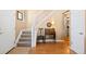 Inviting foyer featuring hardwood floors, staircase, and classic decorative elements at 8403 S Miller Ct, Littleton, CO 80127
