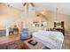 Bright living room featuring high ceilings, staircase, modern furniture, and seamlessly connected to the kitchen area at 8403 S Miller Ct, Littleton, CO 80127