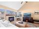 Cozy living room featuring a fireplace, large windows, and comfortable seating at 8403 S Miller Ct, Littleton, CO 80127