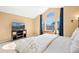Bedroom showcases large window, carpeted floors, and a modern entertainment center at 8403 S Miller Ct, Littleton, CO 80127