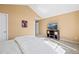 A bedroom boasting neutral paint, plush carpeted floors, and a modern entertainment center at 8403 S Miller Ct, Littleton, CO 80127