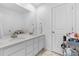 Clean bathroom featuring double sinks with a large mirror and storage at 14800 Hudson St, Thornton, CO 80602