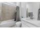 Bathroom featuring a shower-over-tub with gray tile surround, vanity with a white countertop at 14800 Hudson St, Thornton, CO 80602