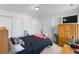 Cozy bedroom with a plush bed, white walls, and a closet with sliding doors at 14800 Hudson St, Thornton, CO 80602