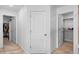 Hallway with neutral colored walls, featuring access to closets with ample storage space at 14800 Hudson St, Thornton, CO 80602