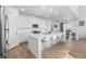 Well-lit kitchen features an island with seating and stainless steel appliances at 14800 Hudson St, Thornton, CO 80602