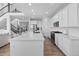 Bright kitchen boasts stainless appliances, white cabinets, and a large center island at 14800 Hudson St, Thornton, CO 80602