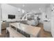 Bright, open-concept living room, kitchen and dining area with long table, island, and contemporary design at 14800 Hudson St, Thornton, CO 80602