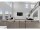 Spacious living room with a large sectional sofa and high windows at 14800 Hudson St, Thornton, CO 80602