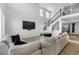 Bright living room with an entertainment center and large sofa under tall ceilings at 14800 Hudson St, Thornton, CO 80602