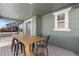 Relaxing covered porch with table and chairs, a delightful outdoor space at 14800 Hudson St, Thornton, CO 80602