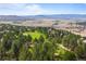 Breathtaking aerial view of a lush golf course nestled in a picturesque landscape with mountain views at 3315 Klondike Pl, Castle Rock, CO 80108