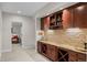 A bar area with cabinets, stone backsplash and countertops for entertaining at 3315 Klondike Pl, Castle Rock, CO 80108