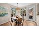 Bright breakfast nook with a modern light fixture, wood flooring, and a view of the outdoor patio at 3315 Klondike Pl, Castle Rock, CO 80108