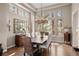 Elegant dining room featuring a large window with natural light, a stylish chandelier, and seating for eight at 3315 Klondike Pl, Castle Rock, CO 80108