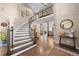 Grand foyer with a curved staircase, hardwood floors, and elegant decor creating a luxurious entrance at 3315 Klondike Pl, Castle Rock, CO 80108