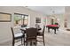 Game room area with game table, four chairs, and a pool table with view of the backyard at 3315 Klondike Pl, Castle Rock, CO 80108
