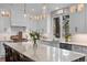 Bright kitchen with an oversized marble island, white cabinets, pendant lighting and stainless appliances at 3315 Klondike Pl, Castle Rock, CO 80108