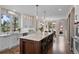 Bright kitchen with an oversized marble island, white cabinets, pendant lighting and stainless appliances at 3315 Klondike Pl, Castle Rock, CO 80108