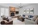 Inviting living room featuring a stone fireplace, built-in cabinets, and comfortable seating arrangement at 3315 Klondike Pl, Castle Rock, CO 80108