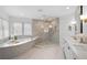 Modern main bathroom featuring a soaking tub, glass-enclosed shower, and double vanity at 3315 Klondike Pl, Castle Rock, CO 80108