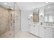 Elegant main bathroom with glass-enclosed shower and double vanity with modern lighting at 3315 Klondike Pl, Castle Rock, CO 80108