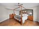 Spacious main bedroom with a four-poster bed, hardwood floors, and dresser at 3315 Klondike Pl, Castle Rock, CO 80108