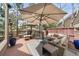 Spacious outdoor deck with cushioned seating, umbrellas, and decorative rug at 3315 Klondike Pl, Castle Rock, CO 80108